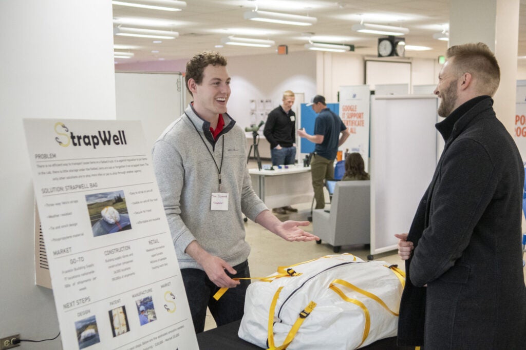 Samuel Slusser, Founder of StrapWell, tabling in front of judgtes