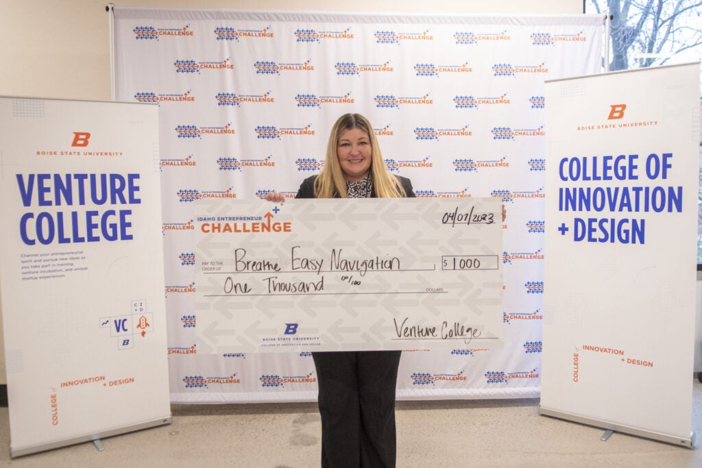 Jacquelyn Ginter-Roush, Founder of Breathe Easy Navigation, posing with prize award
