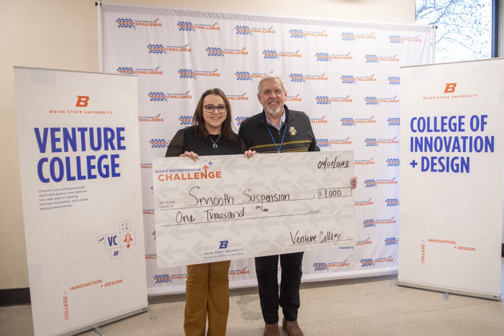 Cassidi Shindler, Founder of Smooth Suspension, with George Tanner, University of Idaho Coach, posing with prize award