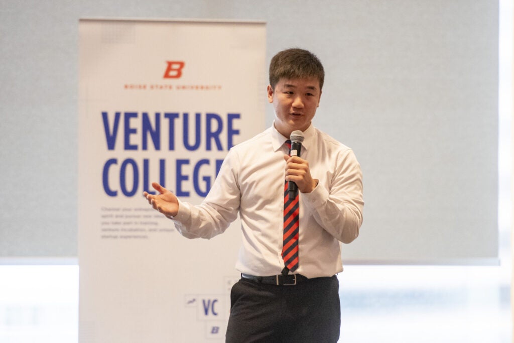 Jae Hyun Kim speaking with a microphone