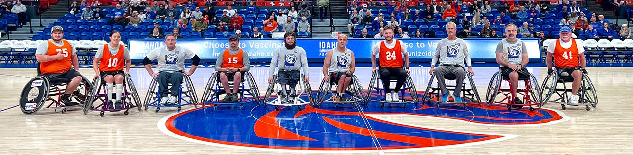 Boise State Adaptive Athletics Basketball team line their wheelchairs up for portrait on the court