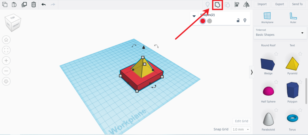 Shapes in work plane with arrow pointing to grouping icon in top right of screen