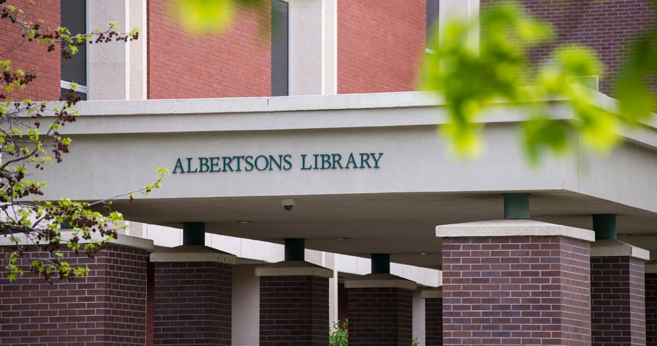 west-facing entrance to the library with sign that reads Albertsons Library