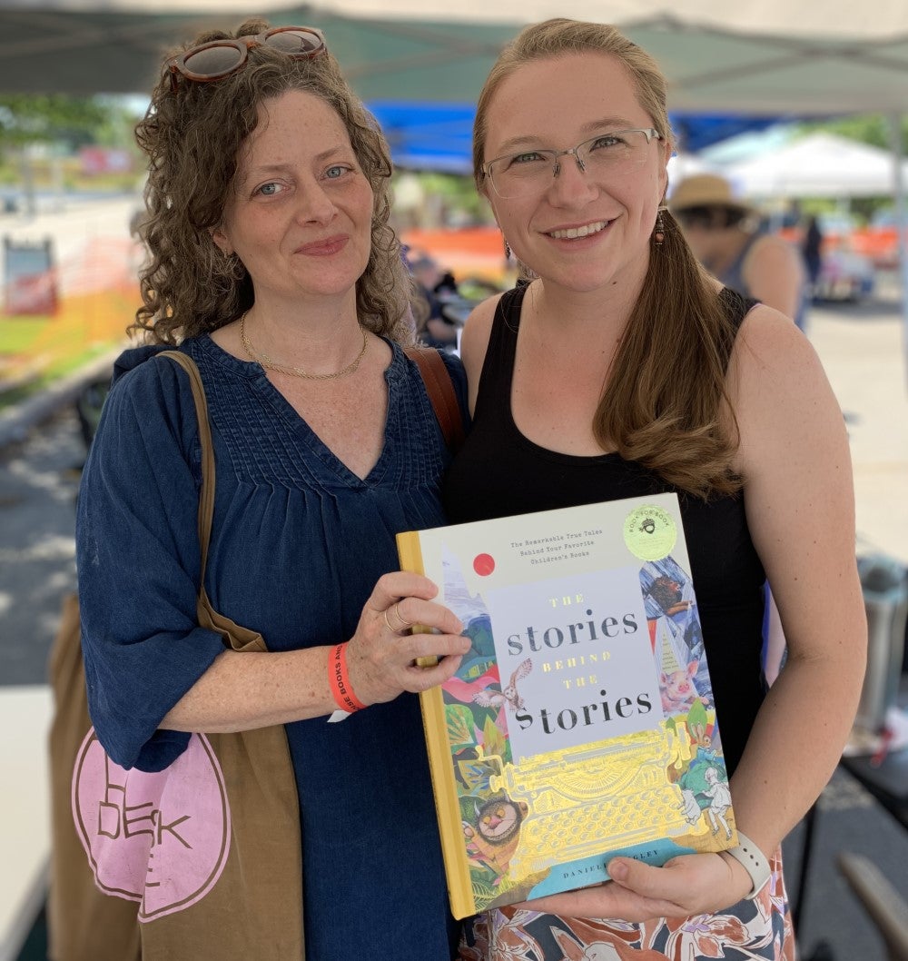 Gwyn and Danielle holding a book