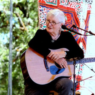 photo of Rosalie Sorrels holding a guitar