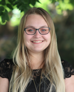 close up headshot of Kolby Alloway outside and wearing eye glasses