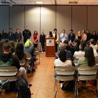 Group of students in front of audience members at the Conference on Language, Identity, and Culture