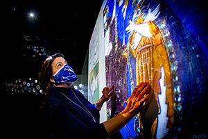 Person engaging with luminary exhibit