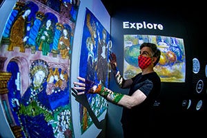 Person engaging with luminary exhibit