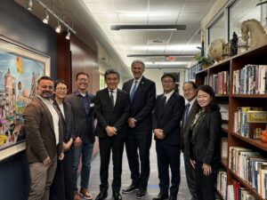 Eight people standing together including Provost of Boise State