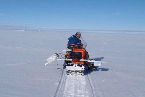 Marshall collecting data from a snowmobile.
