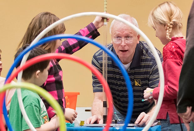 Photo of students and an INL team member working at the Engineering and Science Festival.