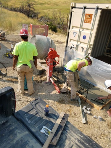 Students build a storage shed in the wilderness.