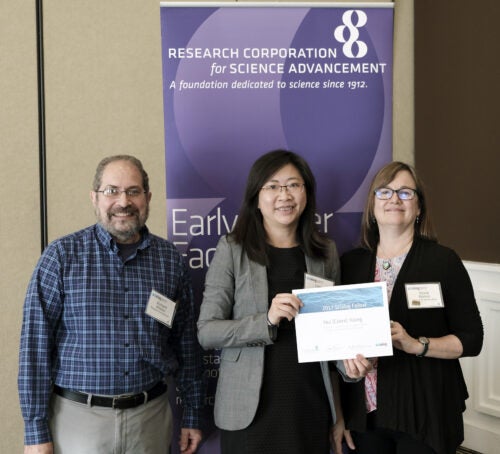 A woman receives her fellowship award