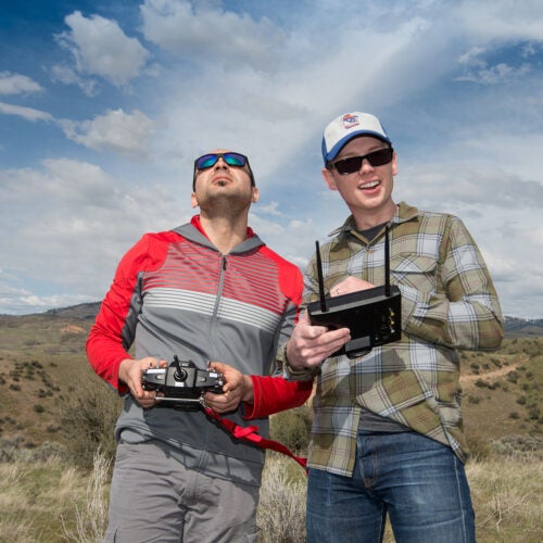 Students posing with drone controls