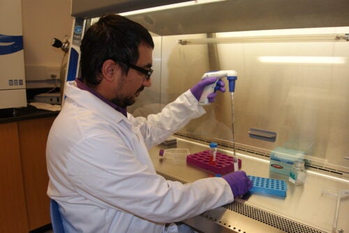 A man measures things in a lab