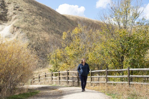 A woman walks in the foothills.