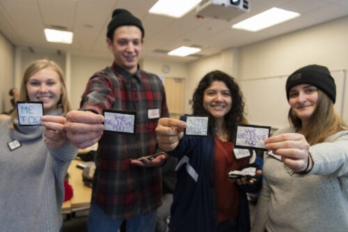 Students holding hand-stitched buttons