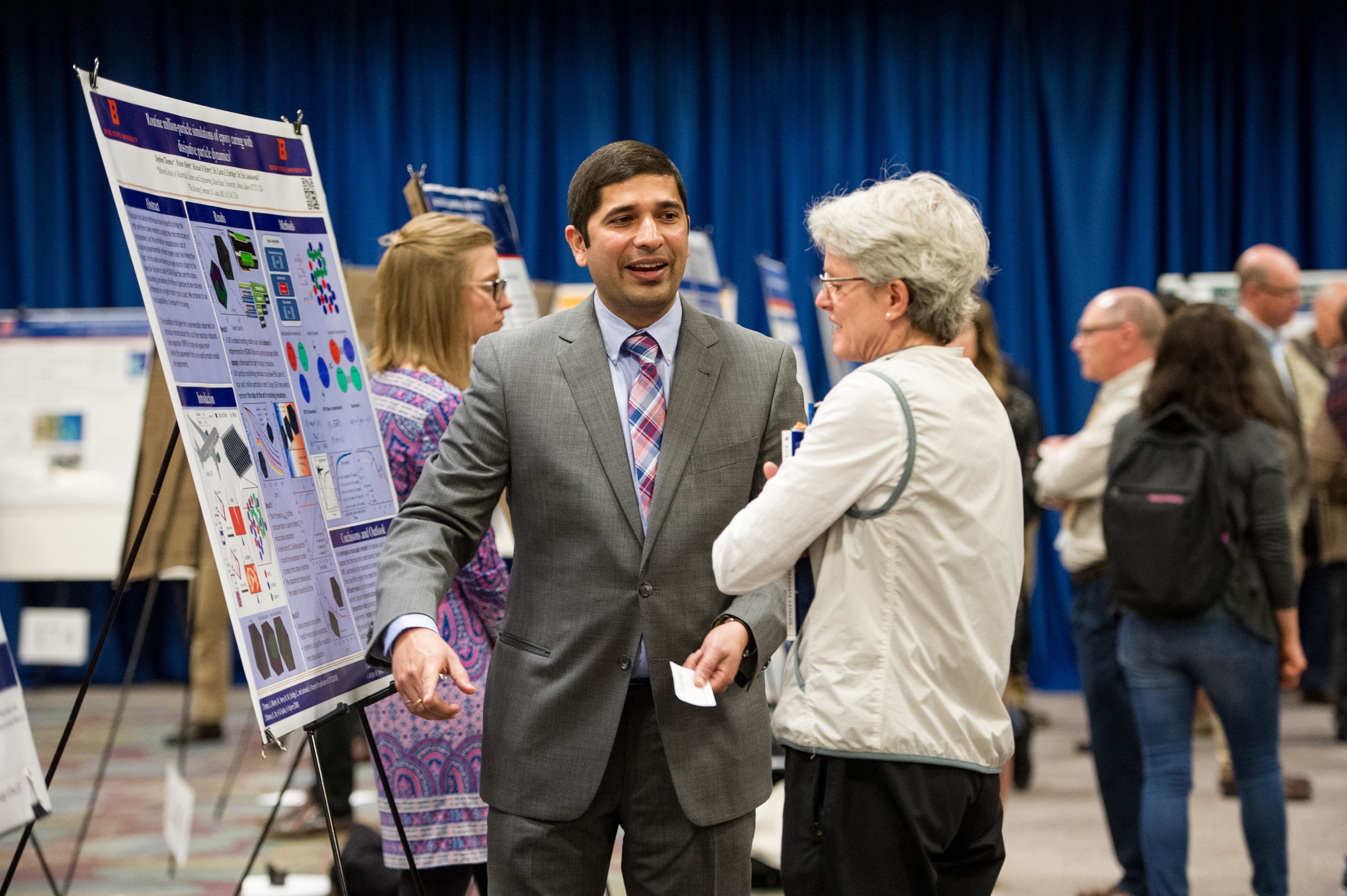 Photo of last year's showcase, student shares his presentation with audience