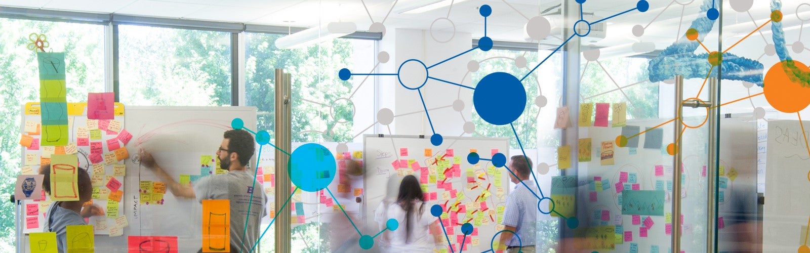 Students and faculty using innovative spaces inside the College of Innovation and Design