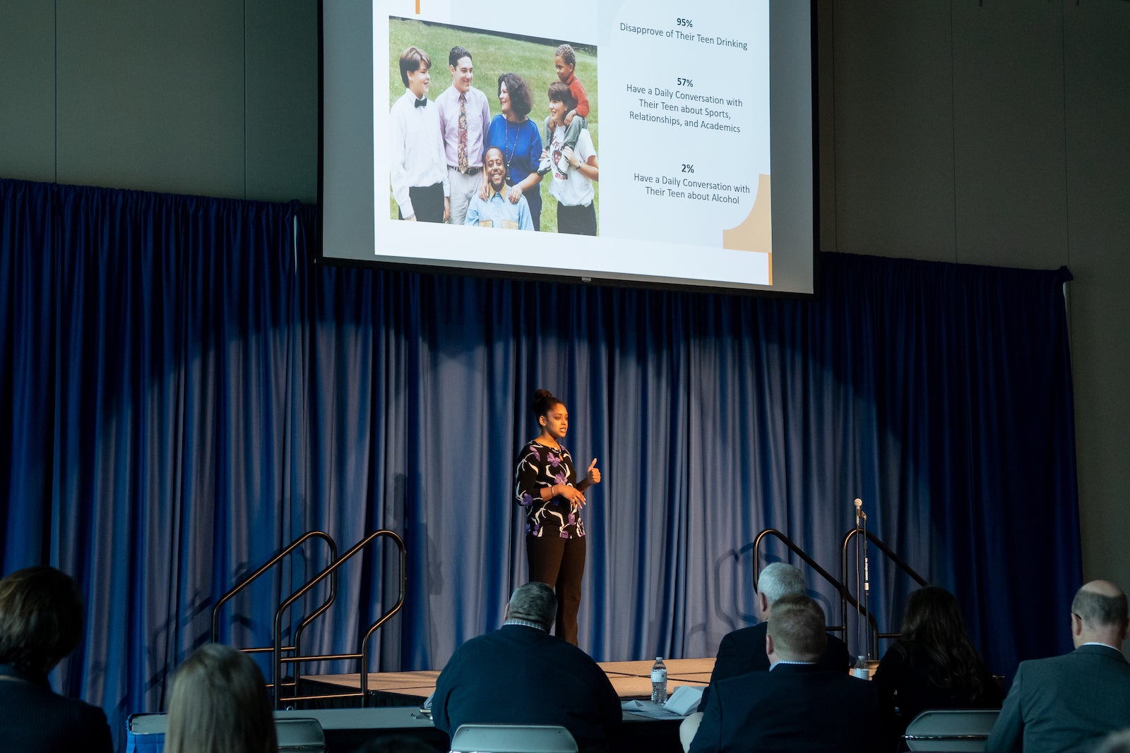 student presenting thesis on stage