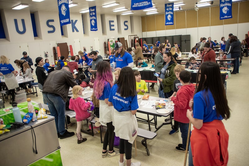 students in a cafeteria practicing STEM activities