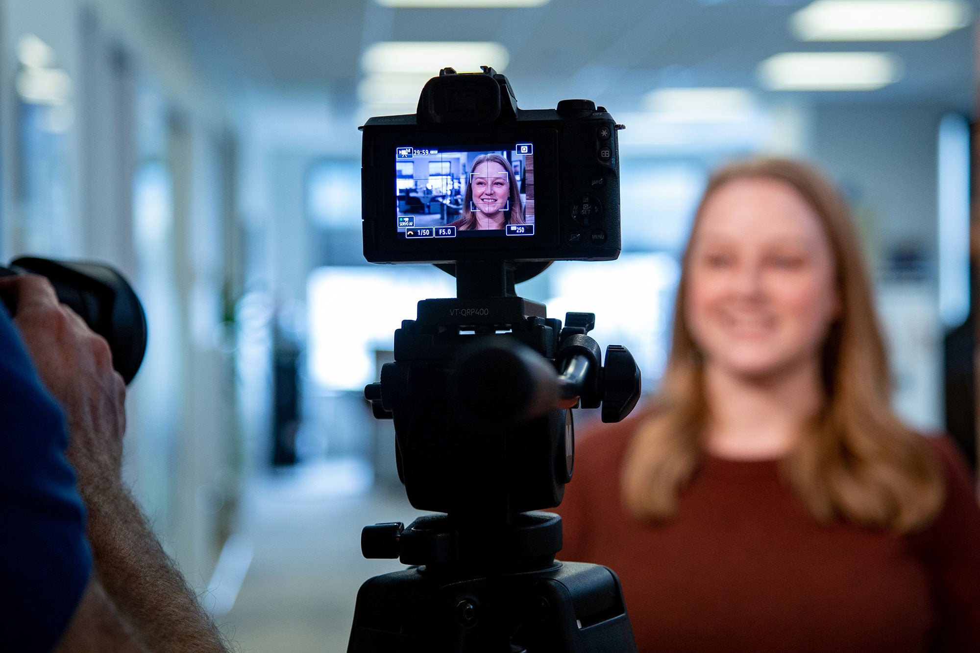 A woman talks at a camera