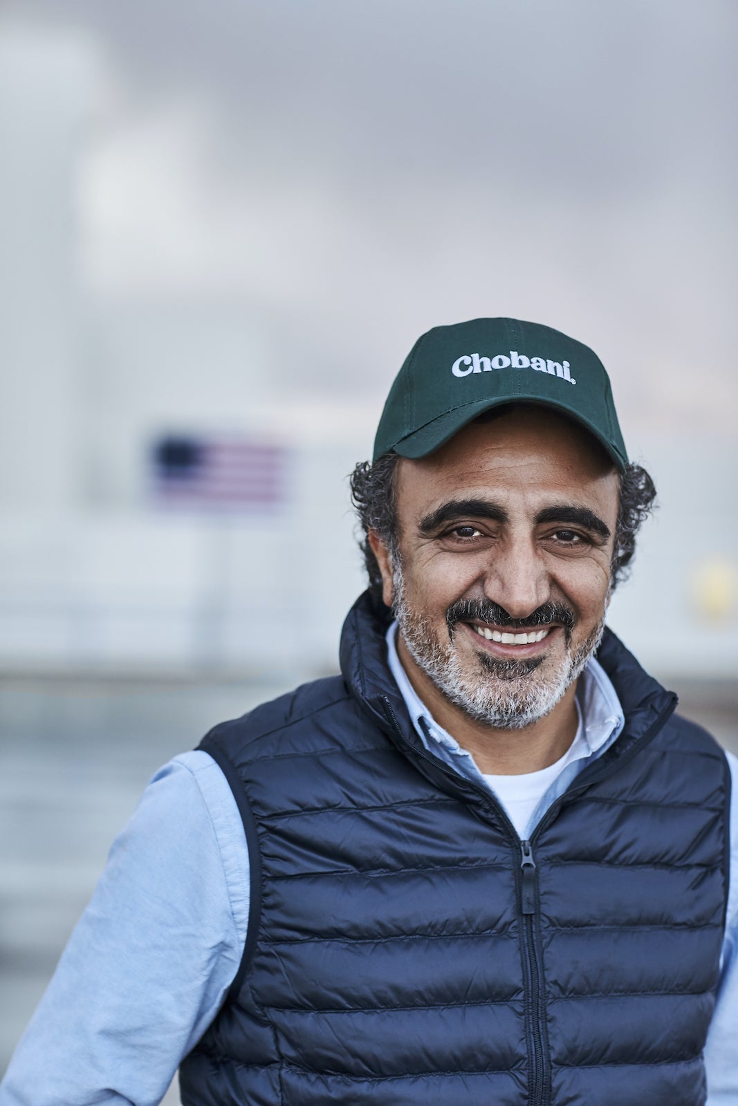 Smiling CEO with a basebal cap.