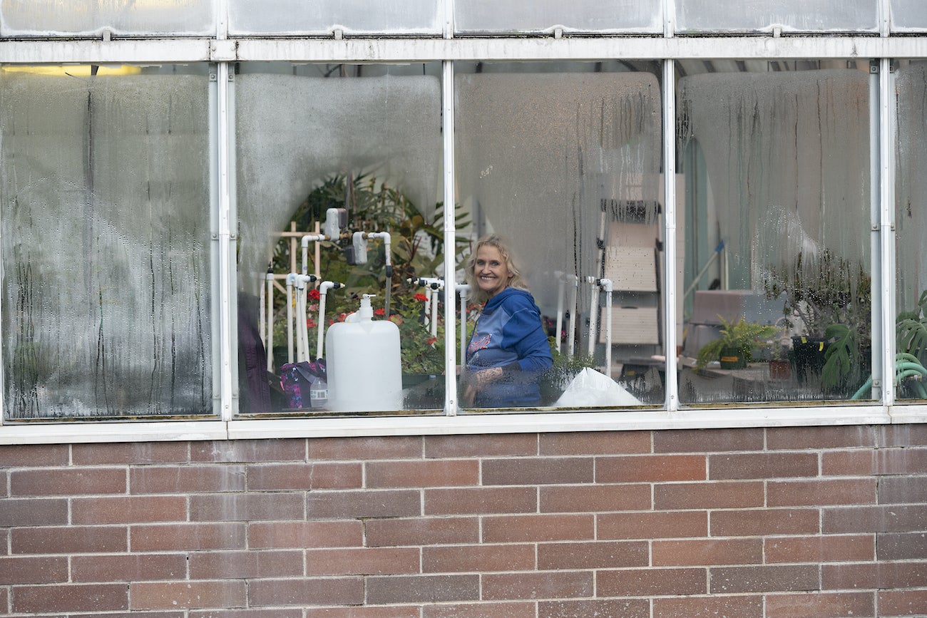 Tami Cox inside a greenhouse