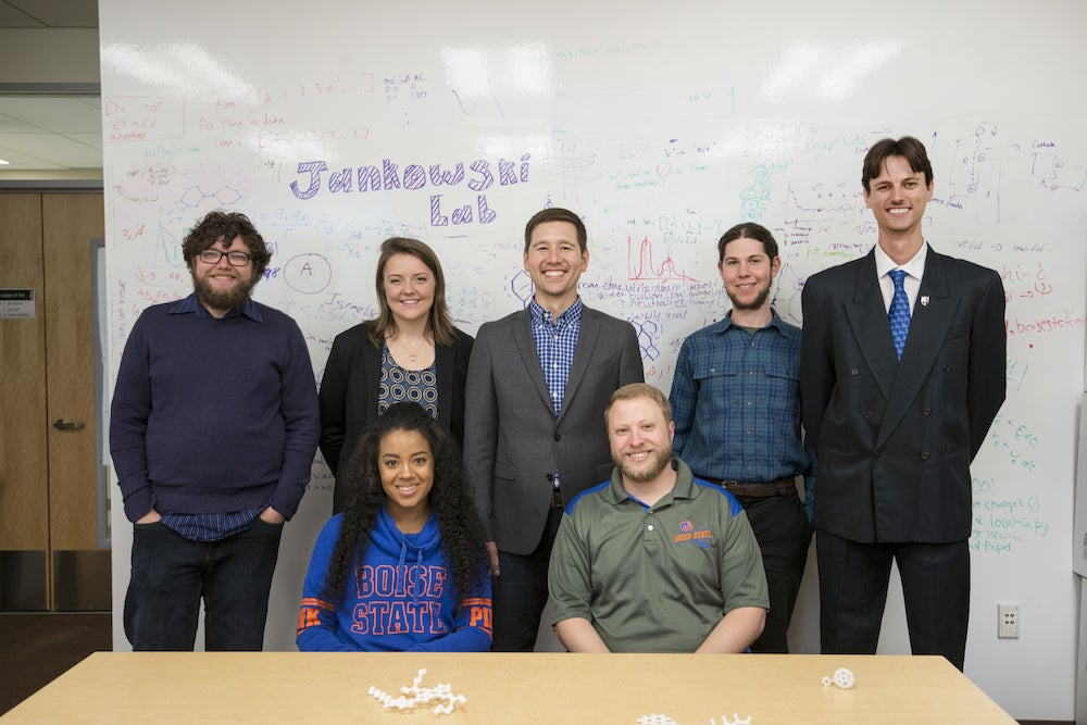 gruop of students stand in front of whiteboard