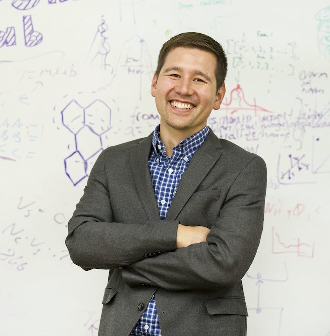 Eric Jankowski stands in front of whiteboard and smiles