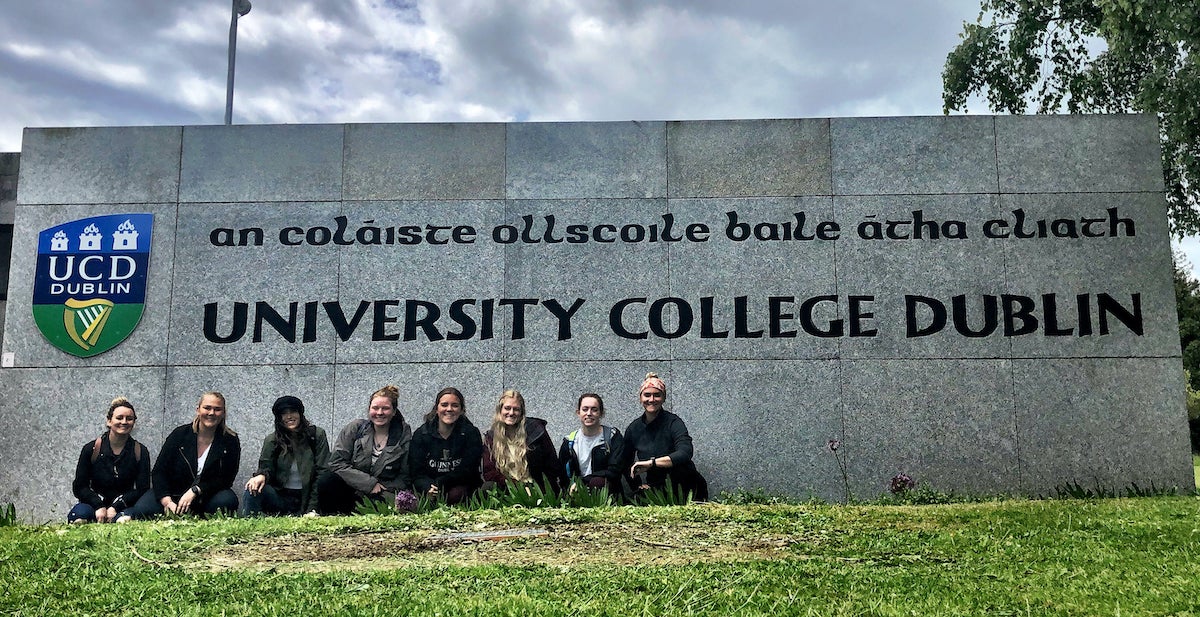 A photo of all 8 students who went to Ireland posing in front of the University College Dublin