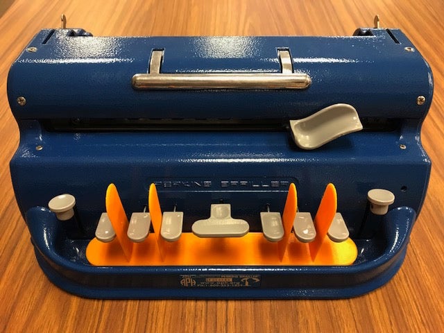 Finger guard in place on braille machine