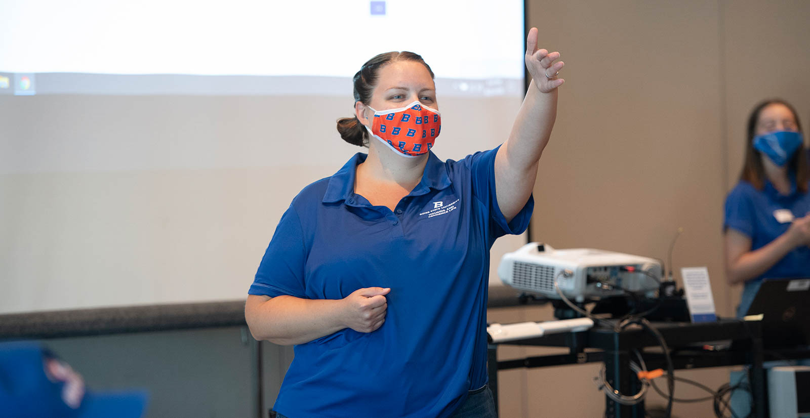 Samantha Davis teaching while wearing a mask. 