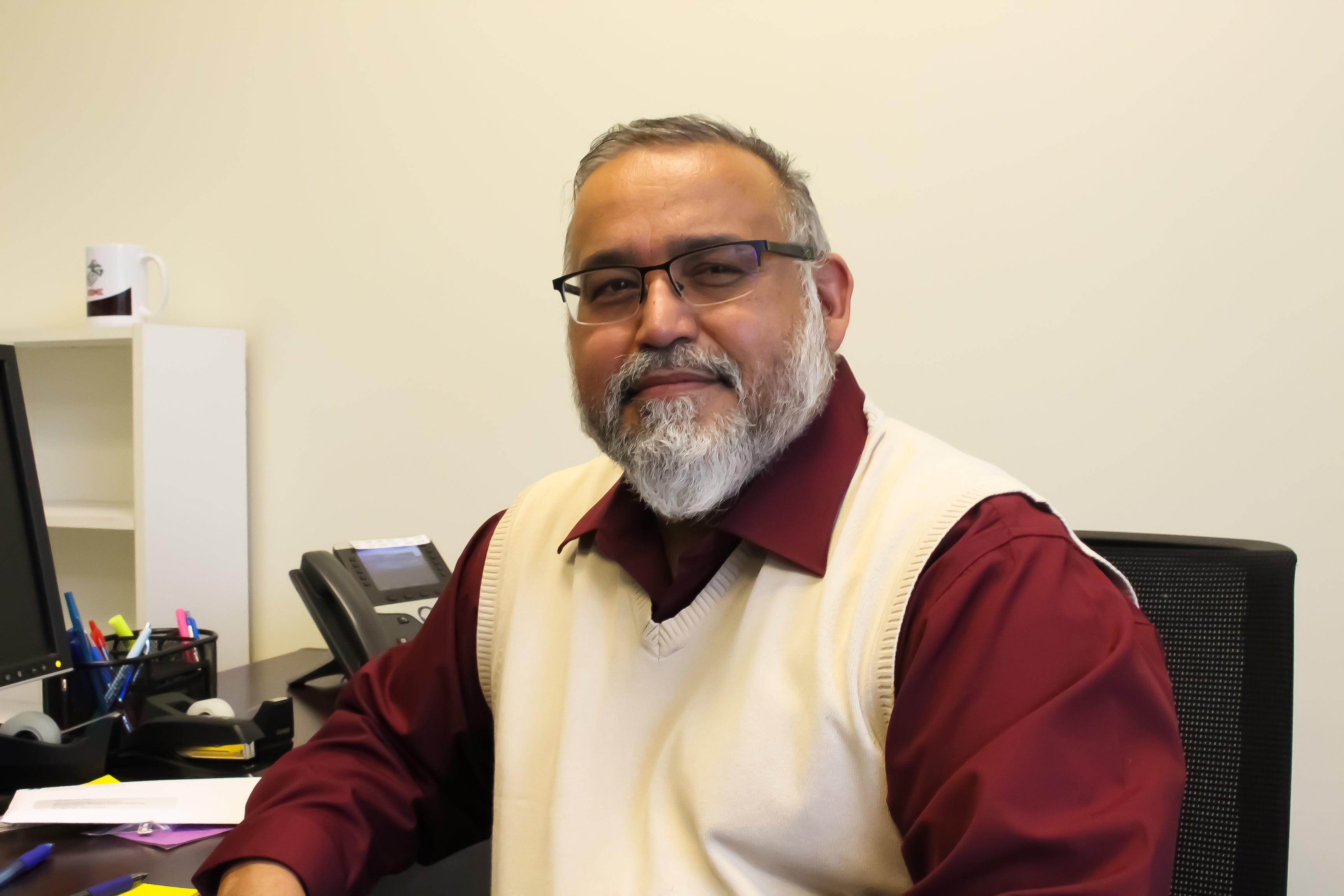 Eluterio sitting at his desk