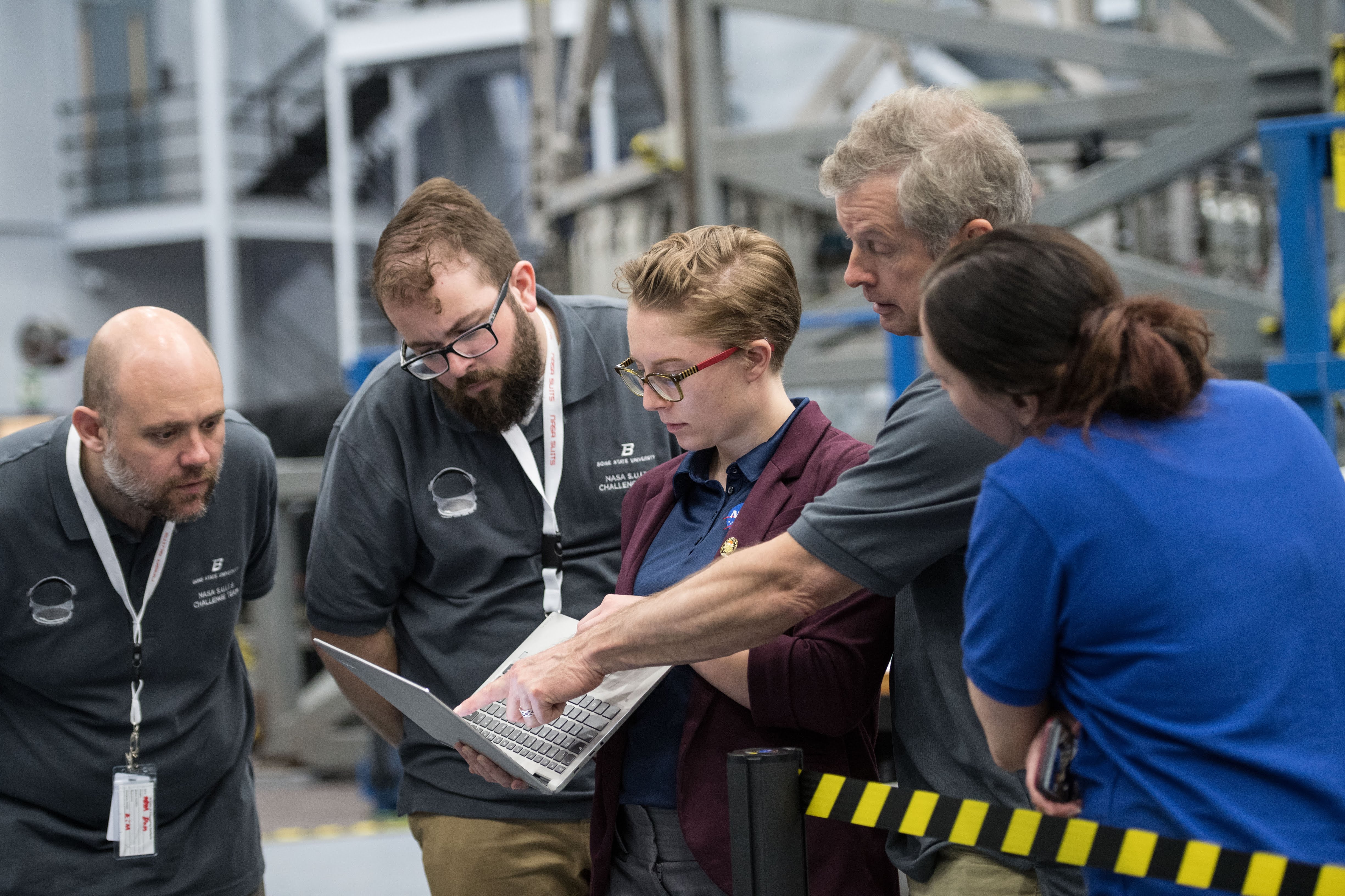 students and Steve Swanson group around laptop at Johnson space center
