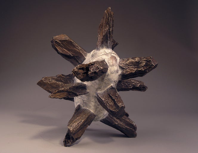 A striking mineral specimen featuring stibnite crystals. The metallic, elongated formations radiate outward, resembling star-like shapes. Their dark metallic luster adds to the unique allure.