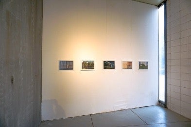 photo of wall with art hanging on it