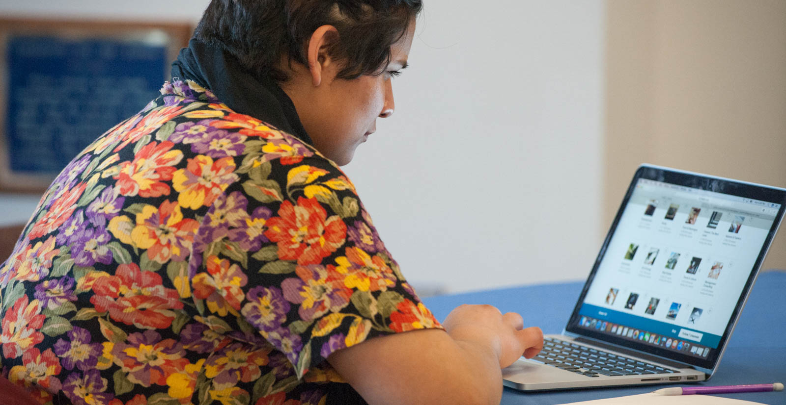 student browses programs on a laptop