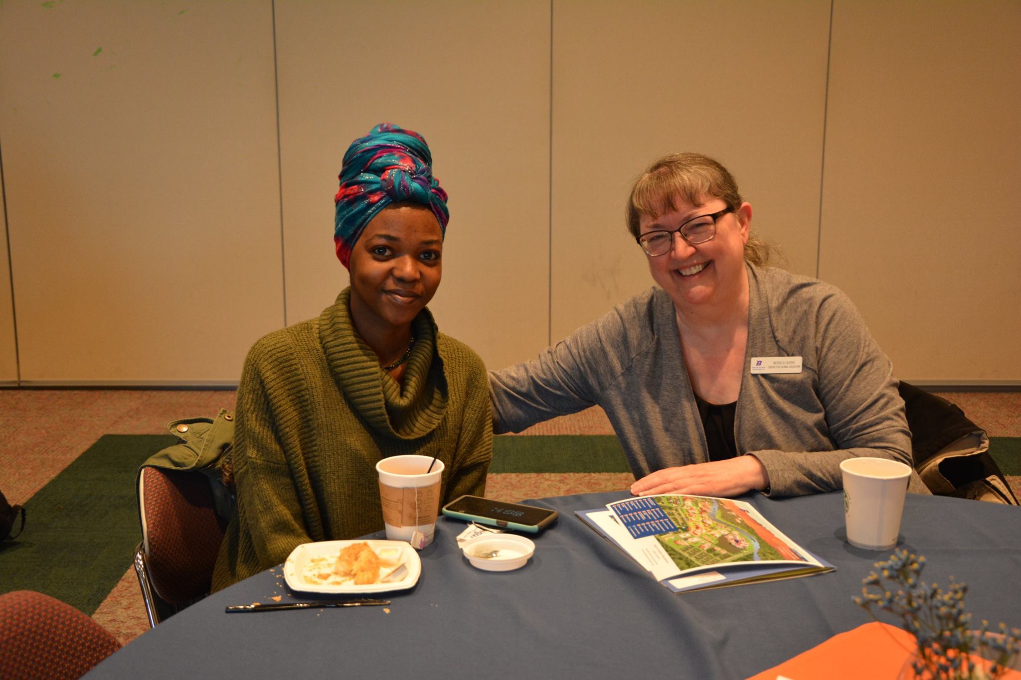 Nuru Soragha and Merrilou Burris sit together at lunch.