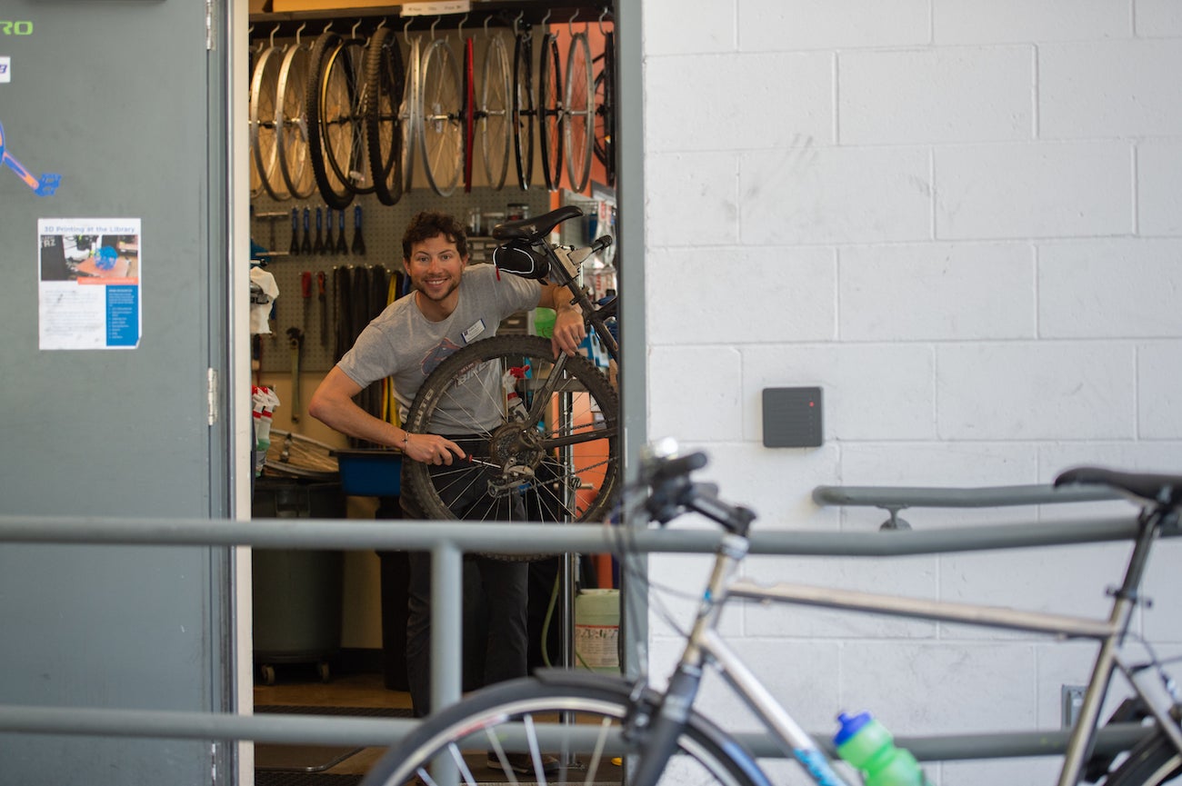An employee of the bike shop repairs a bike.
