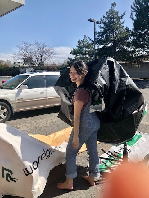 Alaina drying and folding used lumber wrap.