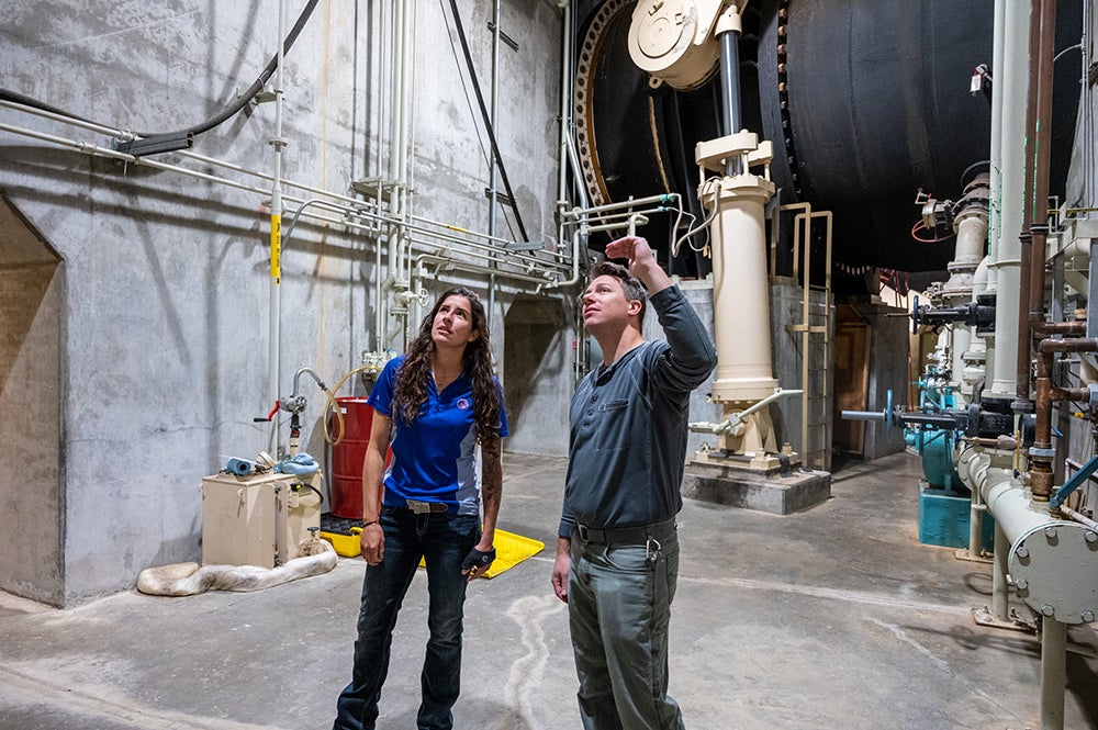 two people inside hydro dam power plant