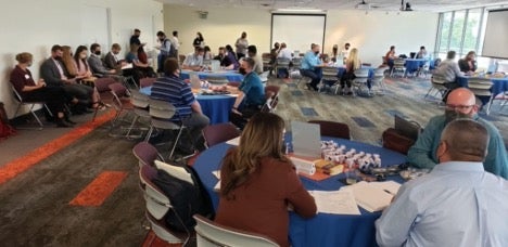 people sit at round tables in an event room