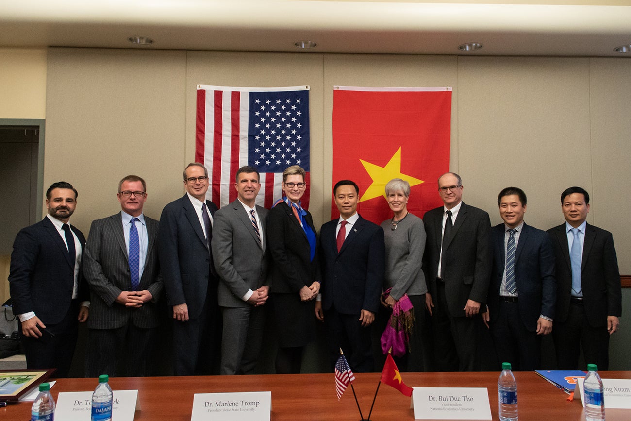 Boise State President Marlene Tromp, National Economics University Chancellor Bui Duc Tho (center) and delegates from both universities met for an agreement signing ceremony.