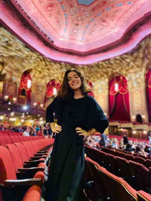 Bella Hall stands in a theatre at film festival