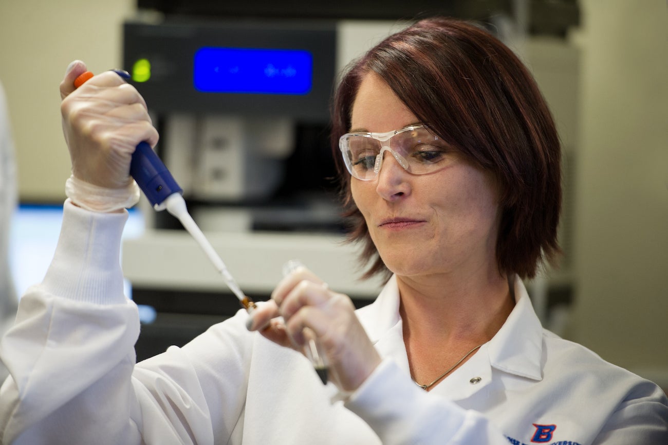 woman holding pipet