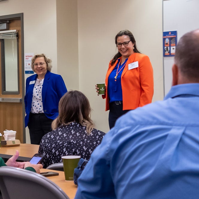 School of Nursing Divisional Dean speaks to Innovation Summit participants in the Norco Building.