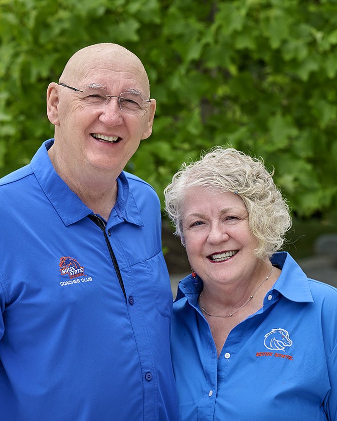Ken and Suz stand outside side by side