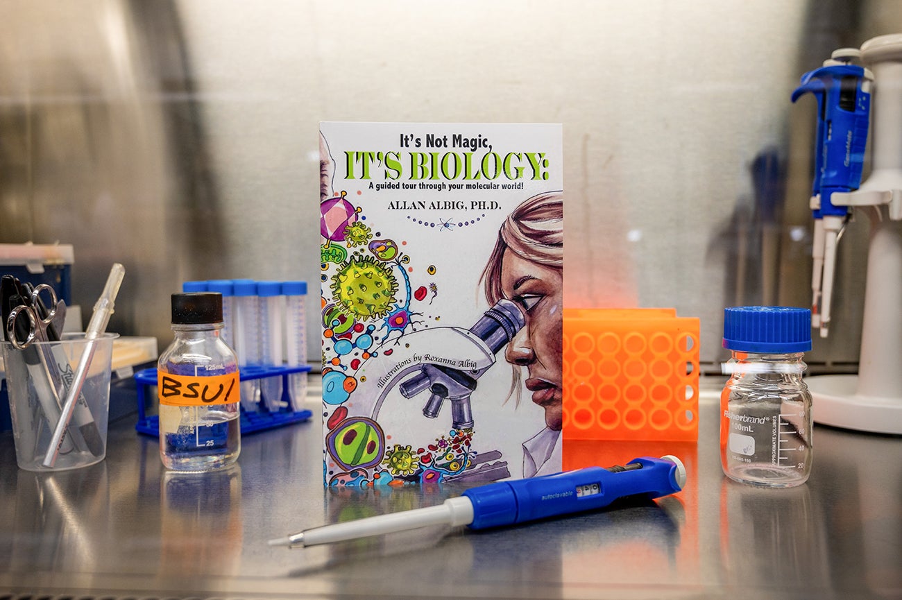 a copy of the book 'It's not magic, it;s biology" on a lab hood surface